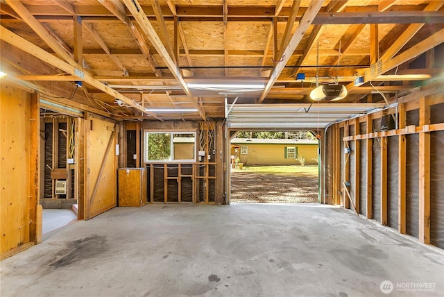 misc room featuring a garage and concrete flooring