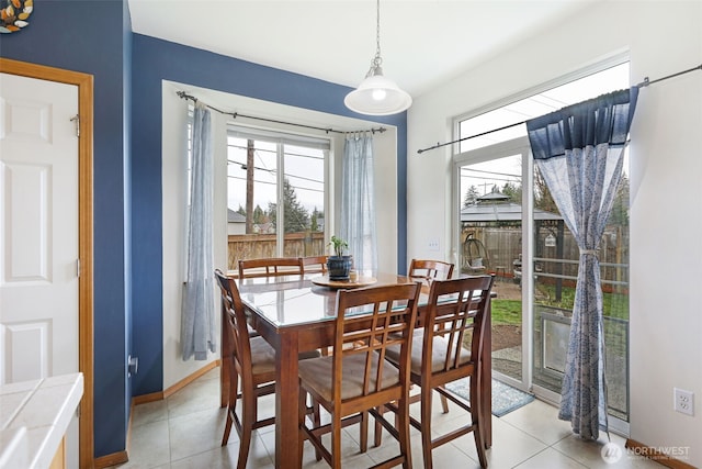 dining room featuring light tile patterned floors and baseboards