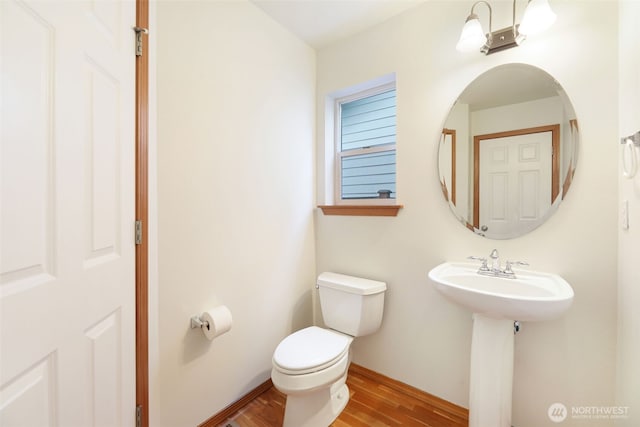 bathroom featuring toilet and wood finished floors