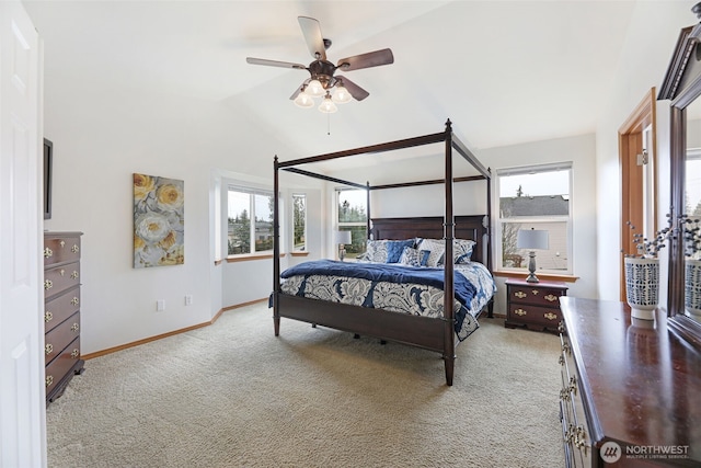 carpeted bedroom with ceiling fan, baseboards, and vaulted ceiling