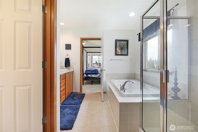 ensuite bathroom with a garden tub, a shower stall, connected bathroom, and tile patterned flooring