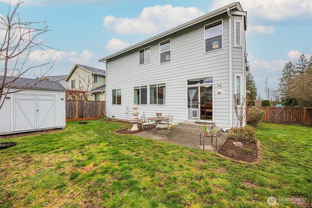 rear view of house with a storage shed, a lawn, an outbuilding, and a fenced backyard