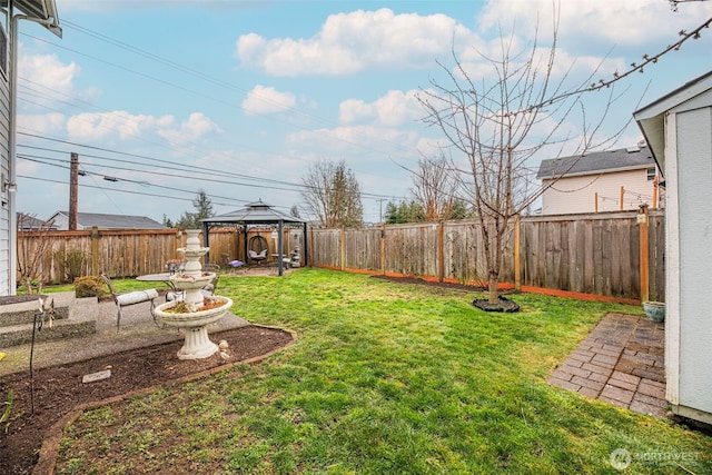 view of yard with a gazebo and a fenced backyard