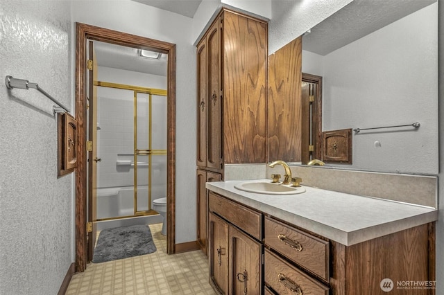 full bathroom featuring a textured wall, toilet, vanity, tile patterned floors, and a stall shower