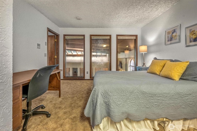 bedroom with carpet flooring, a textured wall, and a textured ceiling