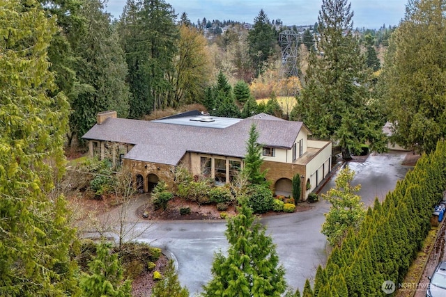 birds eye view of property with a wooded view