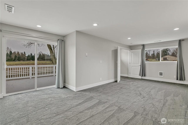 carpeted spare room featuring recessed lighting, visible vents, and baseboards