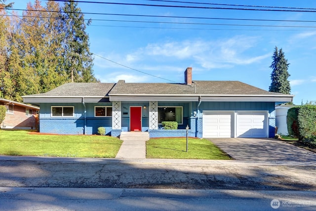 single story home with driveway, a chimney, an attached garage, a front yard, and brick siding