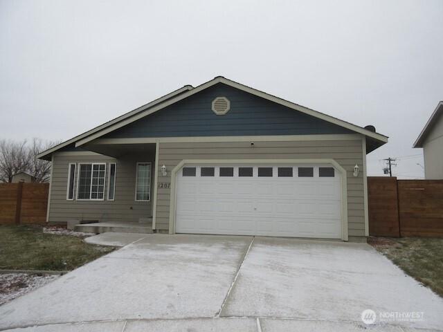 single story home with a garage, fence, and driveway