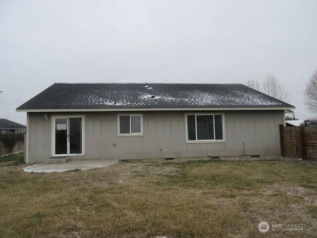 back of house featuring crawl space, fence, a lawn, and a patio