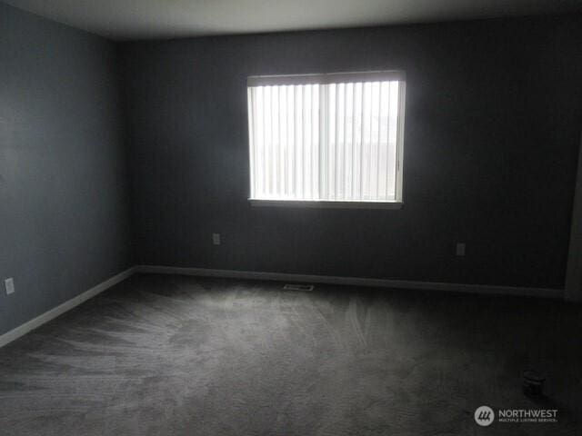 empty room with carpet floors and baseboards