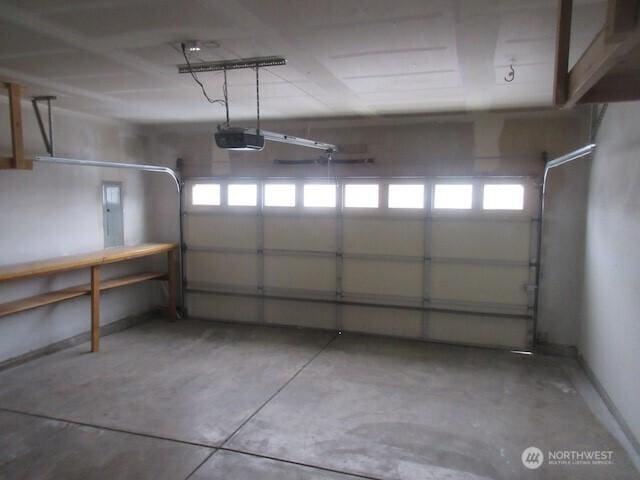 garage featuring a garage door opener and electric panel