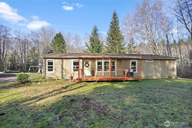 back of house with crawl space, a lawn, and a wooden deck