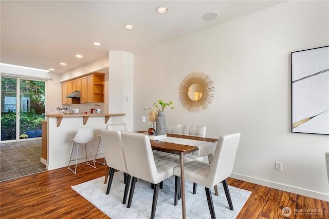 dining space with baseboards, dark wood-style flooring, and recessed lighting