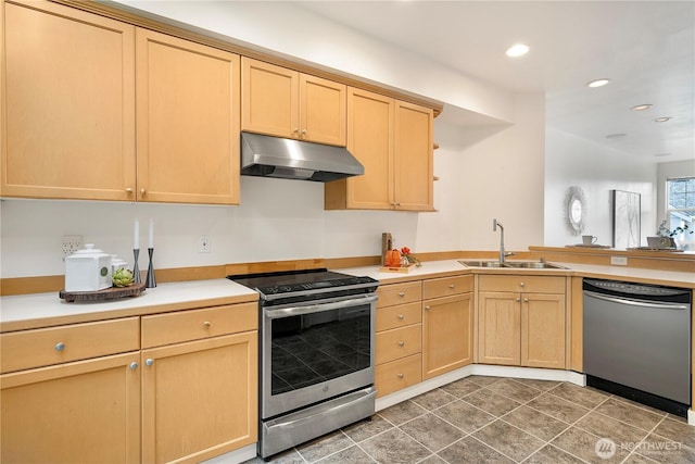 kitchen featuring a peninsula, stainless steel appliances, light brown cabinetry, under cabinet range hood, and a sink