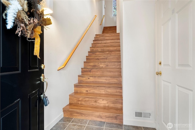 stairs featuring visible vents and tile patterned floors