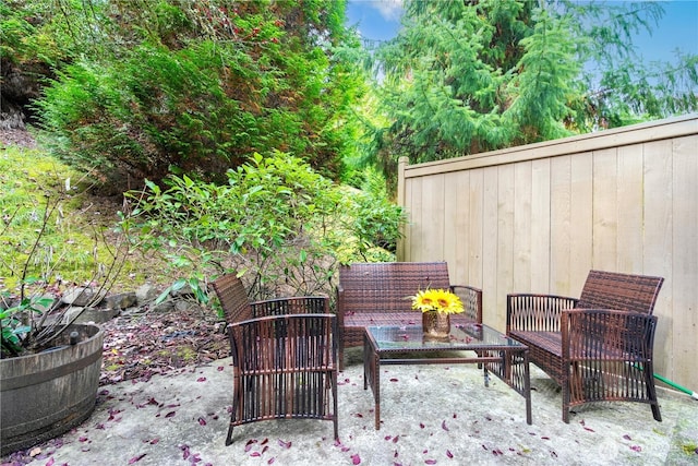 view of patio featuring outdoor lounge area and fence