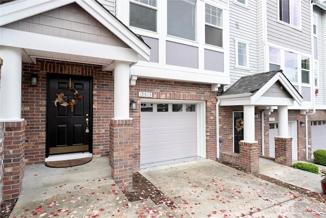 entrance to property featuring brick siding and driveway