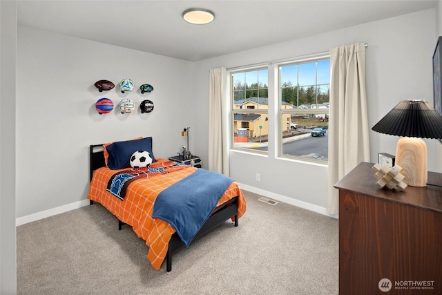 carpeted bedroom with visible vents and baseboards