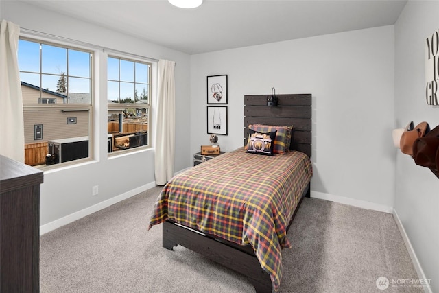 carpeted bedroom featuring baseboards