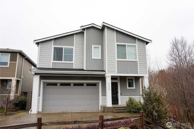 view of front of home featuring driveway, an attached garage, and fence