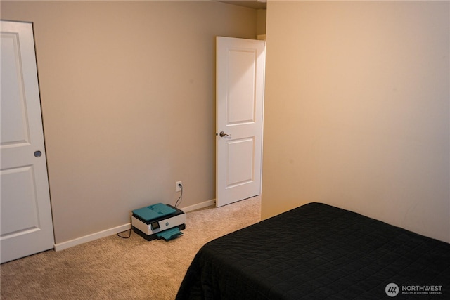 unfurnished bedroom with light carpet and baseboards