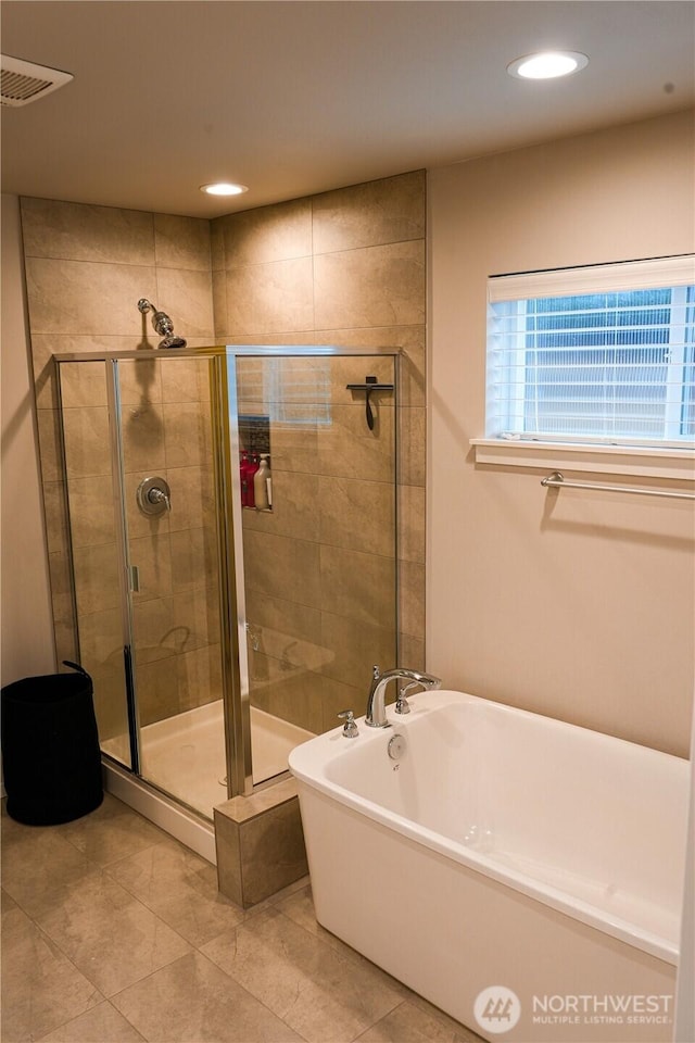 full bath with a stall shower, a soaking tub, visible vents, and recessed lighting