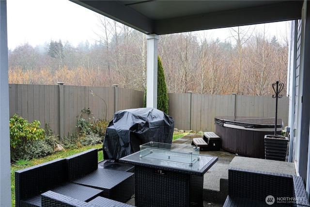 view of patio featuring outdoor lounge area, grilling area, a fenced backyard, and a hot tub