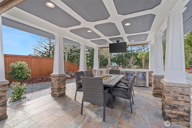 view of patio / terrace with fence, exterior kitchen, and outdoor dining space
