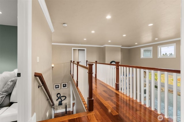 hall featuring ornamental molding, recessed lighting, an upstairs landing, and wood finished floors