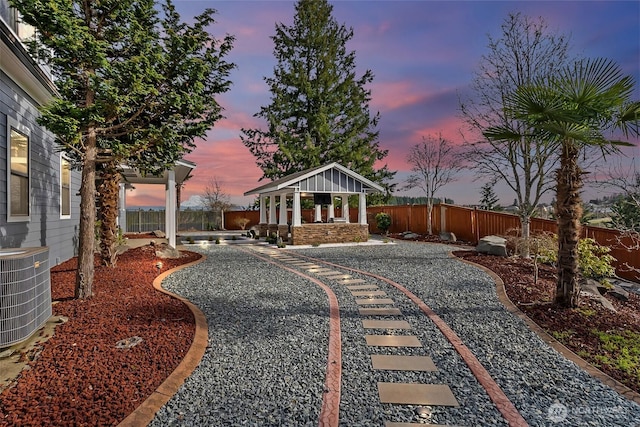 exterior space featuring a gazebo, central AC, a patio, and a fenced backyard