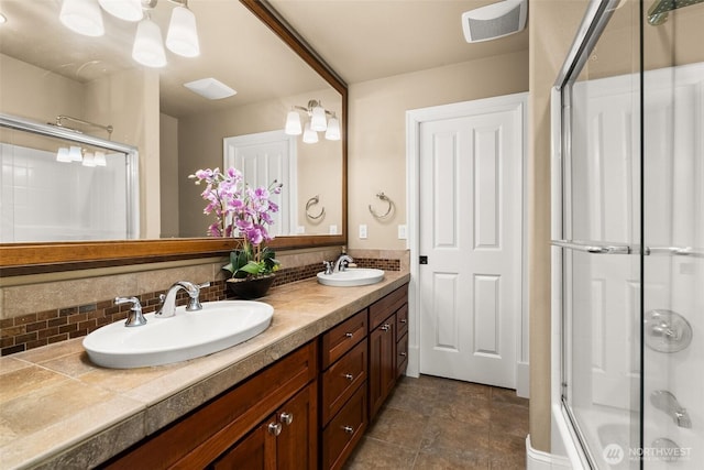 full bathroom featuring an enclosed shower, backsplash, and a sink