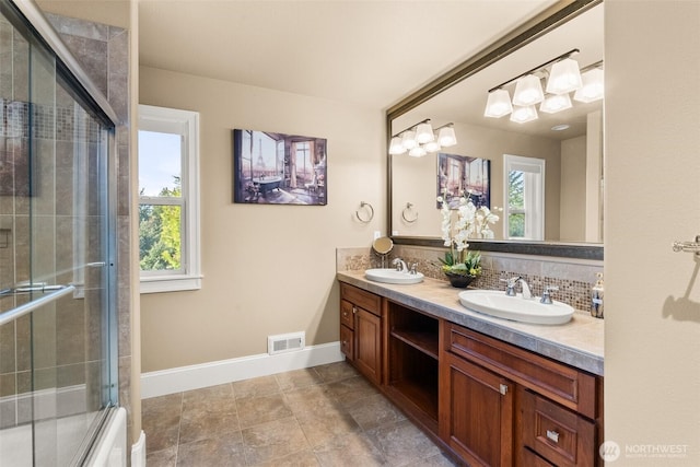 bathroom featuring a sink, visible vents, and a healthy amount of sunlight