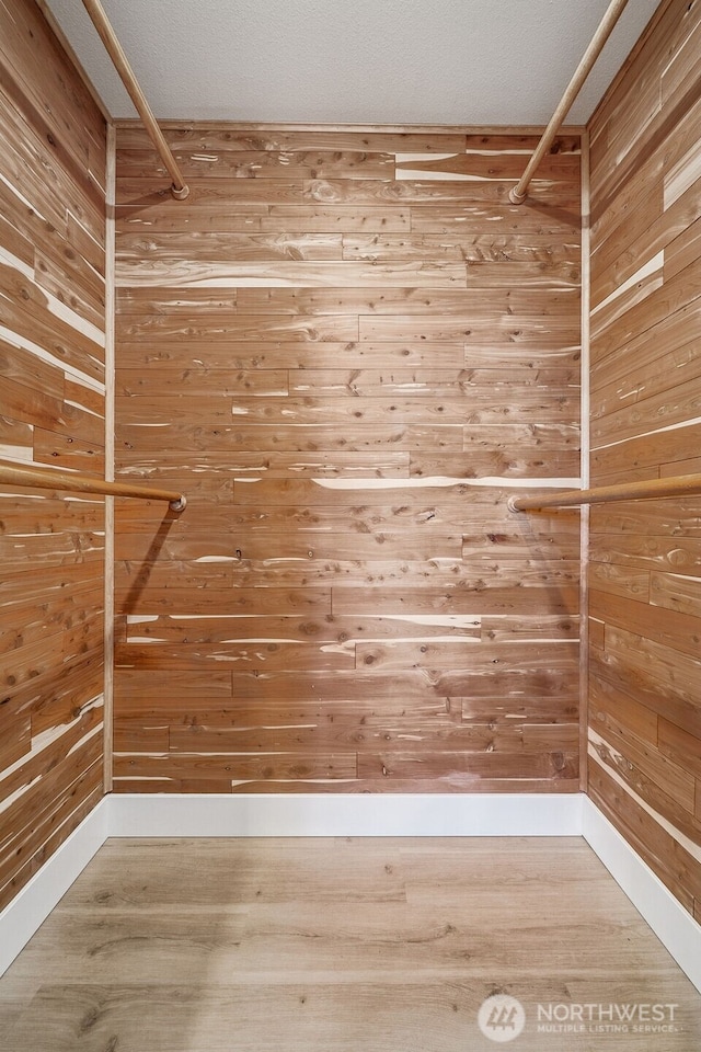 spacious closet featuring wood finished floors