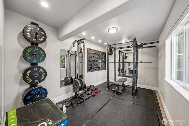 exercise area featuring a wealth of natural light, baseboards, and recessed lighting