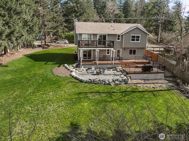 rear view of house with fence, a lawn, and a wooden deck