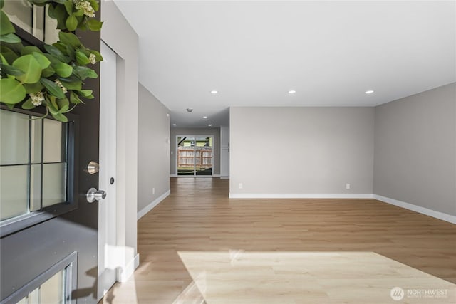 interior space with light wood-type flooring, baseboards, and recessed lighting