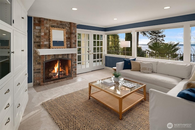 living room featuring recessed lighting, french doors, light carpet, and a fireplace