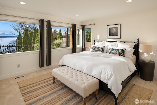 bedroom featuring carpet floors, recessed lighting, visible vents, and multiple windows