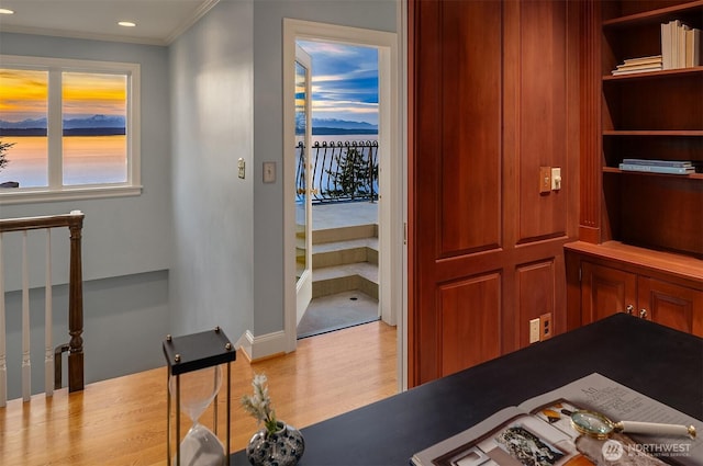 interior space with ornamental molding and wood finished floors