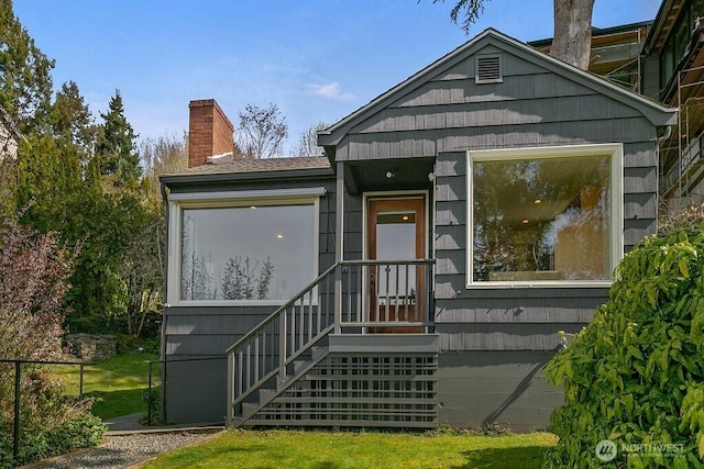 view of front of home featuring a chimney