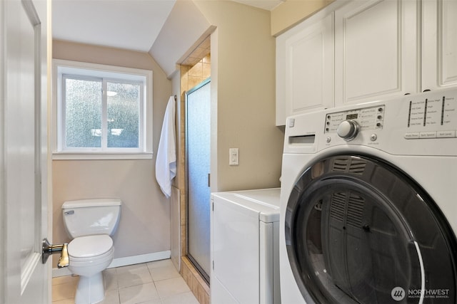 laundry room with laundry area, separate washer and dryer, light tile patterned flooring, and baseboards