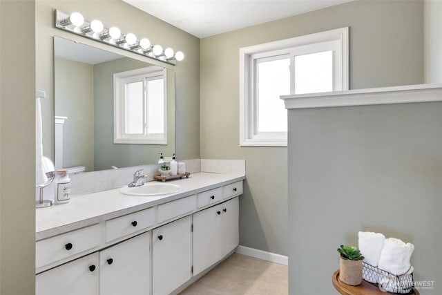 bathroom with baseboards and vanity