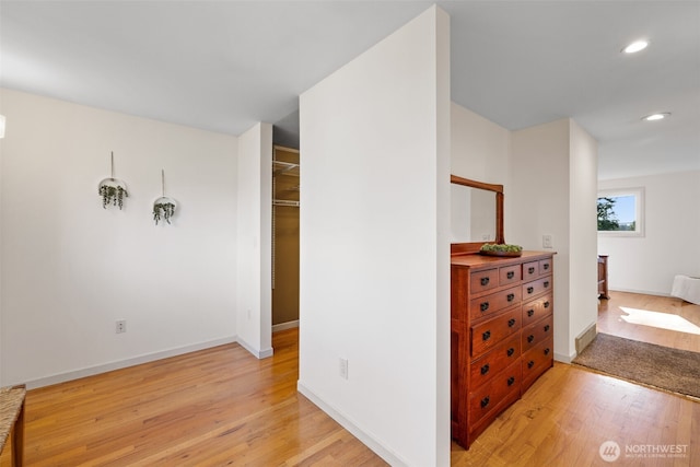 interior space with baseboards, light wood-type flooring, and recessed lighting