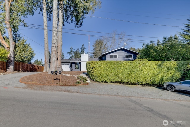 view of front of house with fence and driveway