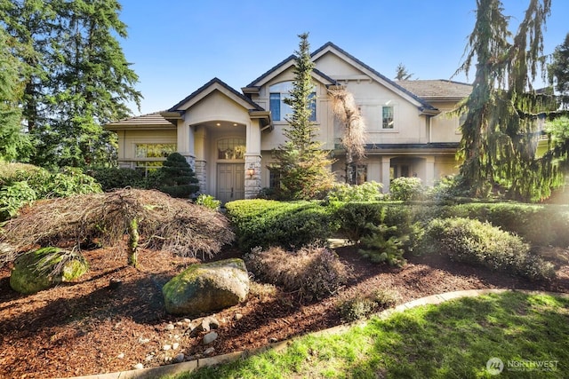 craftsman house featuring stone siding and stucco siding