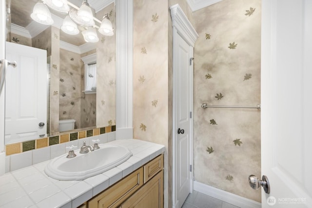 bathroom featuring toilet, wallpapered walls, and crown molding