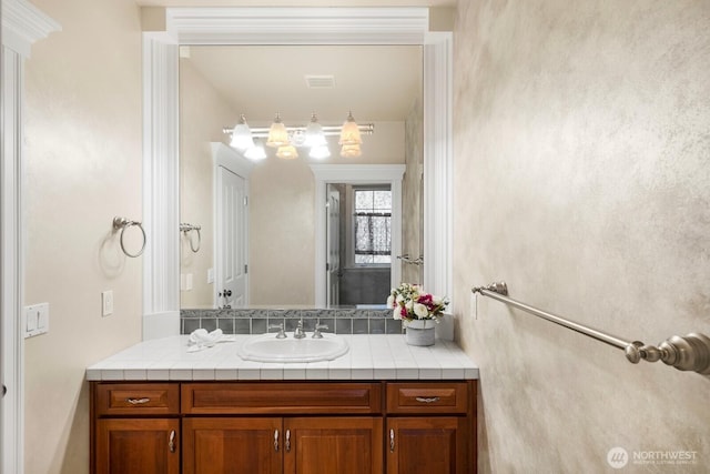 bathroom with visible vents and vanity