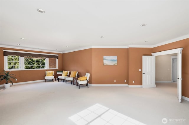 living area featuring baseboards, ornamental molding, and light colored carpet