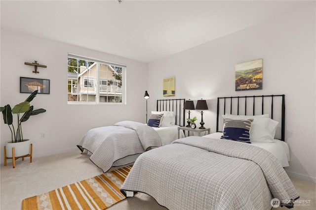 bedroom with light colored carpet and baseboards